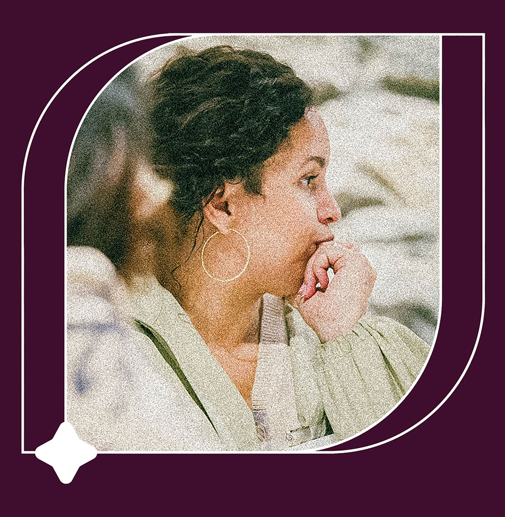 A woman at a conference thinking