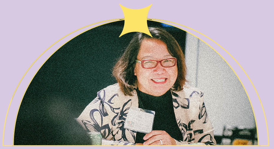 A woman smiles while collaborating