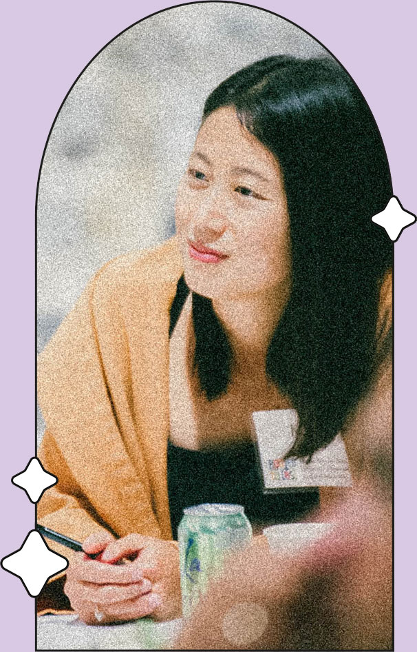 A woman listens at a conference